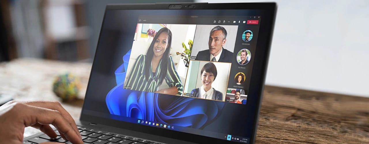 Close-up of the Lenovo ThinkPad X1 Nano Gen 3 laptop in use on a table, showing a video call on the display.