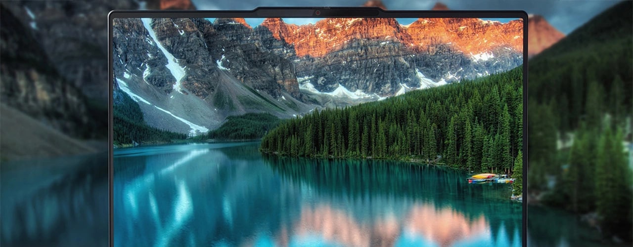 Stunning visual of snow-capped mountains & river on the display of the Lenovo ThinkBook 16p Gen 4 laptop & surrounding the device, which appears to be floating atop the river.